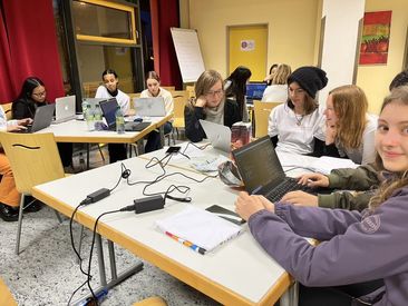 Young women eager in coding and helping each other
